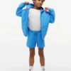 Pantalón corto de chándal para niño con logotipo de bandera en tonos Pantalón corto de chándal para niño con logotipo de bandera en tonos