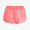 Pantalones cortos infantiles con logo Tommy y purpurina