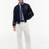 Pantalones holgados con pliegues y tacto de papel Pantalones holgados con pliegues y tacto de papel