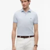 Polo de corte entallado con ribetes