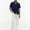 Polo de corte regular con bolsillo de malla