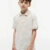 Polo elástico con estampado tropical para niño