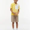 Polo elástico con logo y bloques de color para niño Polo elástico con logo y bloques de color para niño